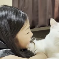 ベッドの上に寝転ぶ子どもと猫