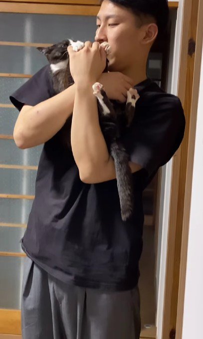 猫を抱っこする男性