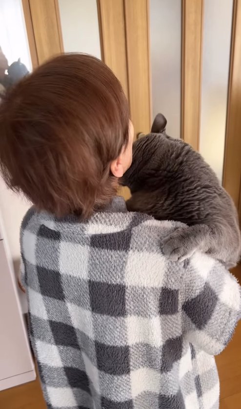 おばあちゃんの顎に顔を擦り付けている猫