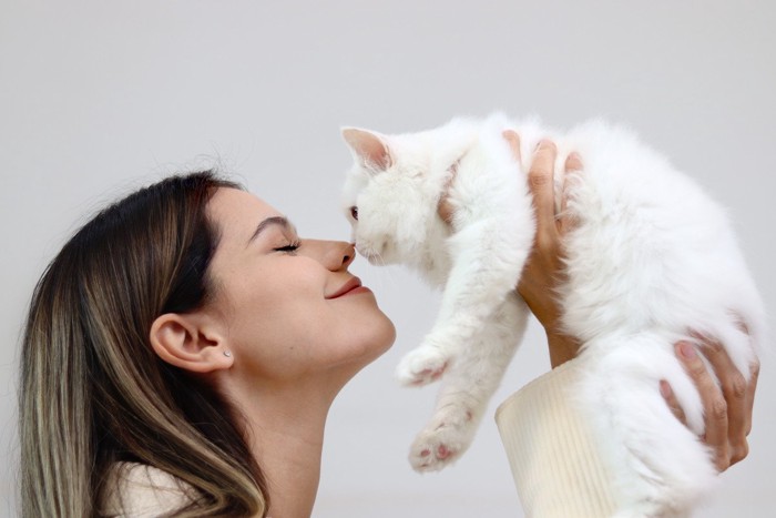 飼い主の女性と白猫