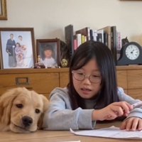 暇そうな顔で女の子にもたれかかる犬