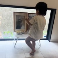 遺影の前に立つ子ども