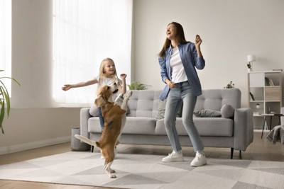 踊る人二人と立ち上がる犬