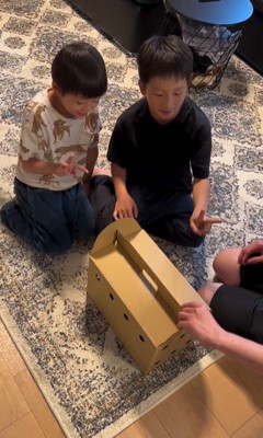 箱の前で指折りする子供たち