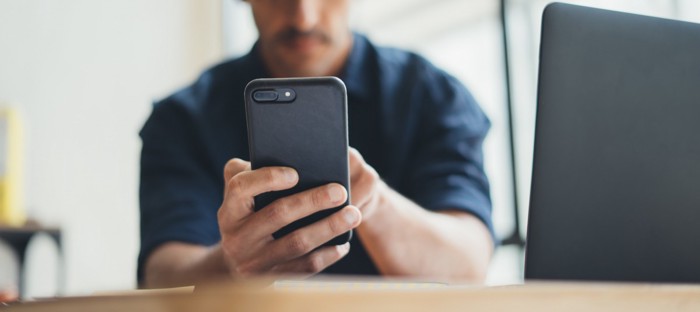 Close-up photo of male hands with smartphone