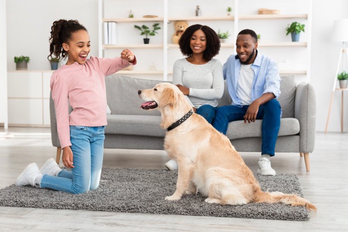 フードを持ってる子供と犬