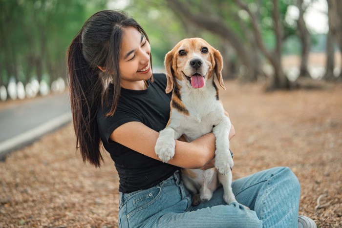 犬を抱っこする女性