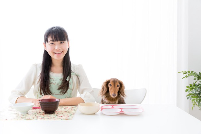 食事する女性と犬