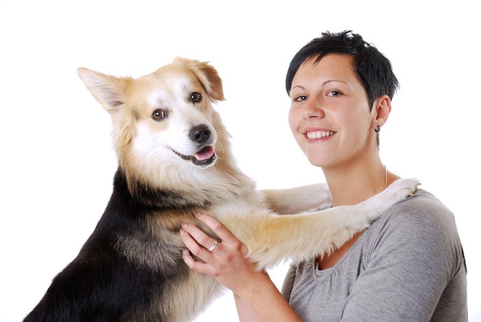 女性に前足をかける犬