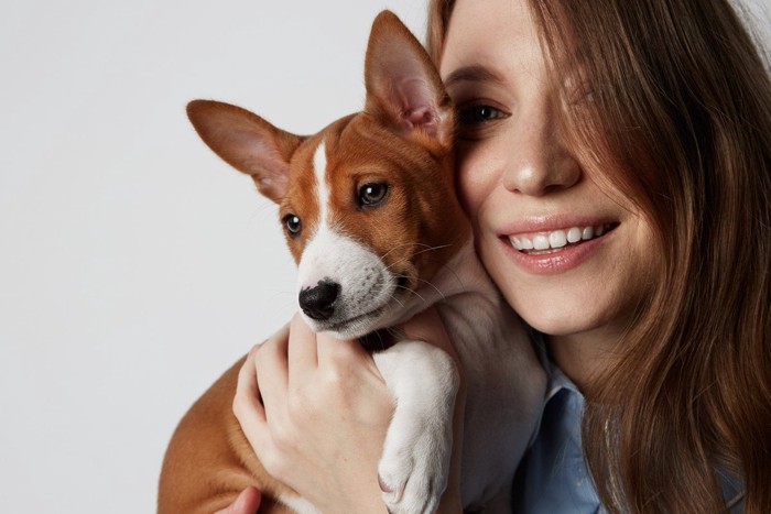 嫌そうな犬と嬉しそうな女性