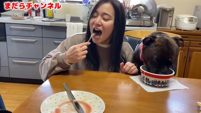 肉を食べる女性と犬