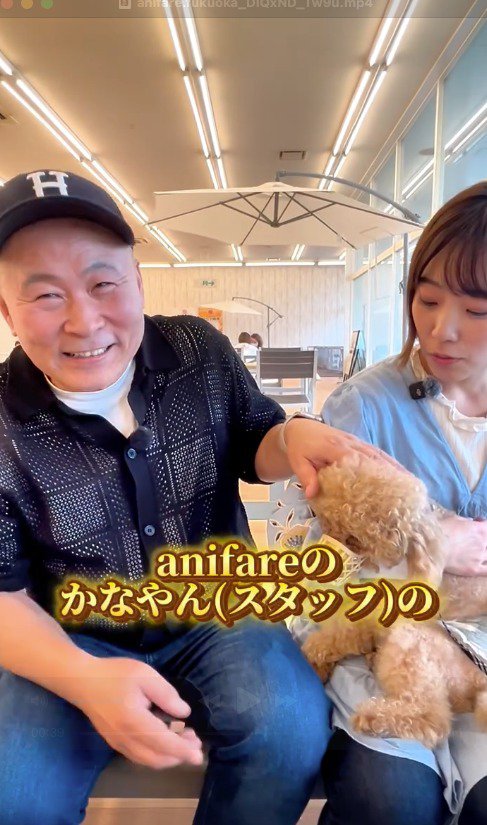 スタッフと話す笑顔の男性