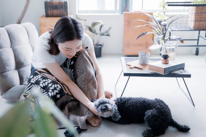 部屋でくつろぐ女性と犬